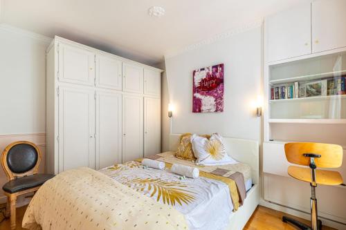 une petite chambre avec un lit et une chaise dans l'établissement GuestReady - Appartement baigné de lumière au 7e., à Paris