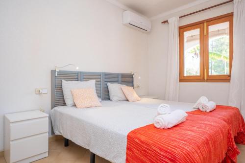 a bedroom with a bed with towels on it at Boreal in Alcudia