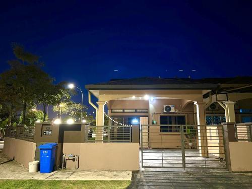 a house with a gate in front of it at night at Quayside Cove Homestay - Corner House, Shah Alam Rimbayu Netflix Syok TV BBQ in Shah Alam