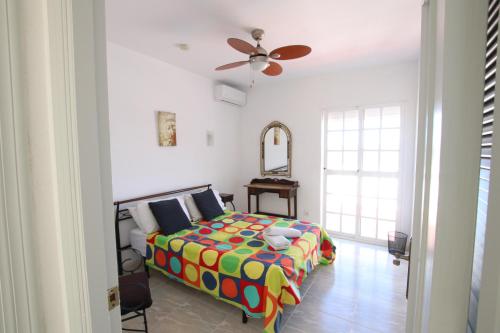 a bedroom with a bed and a ceiling fan at TESS Villa Ellen Maria: Space, Activity, Freedom! in Alhaurín de la Torre