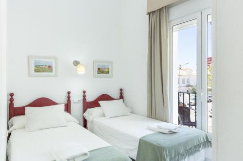 En eller flere senge i et værelse på Amplio apartamento en Playa de Regla 2