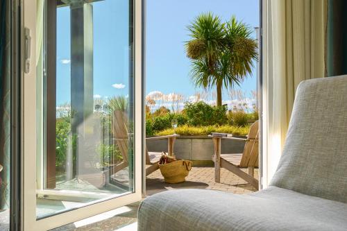 a room with a bed and a sliding glass door at Inchydoney Island Lodge & Spa in Clonakilty