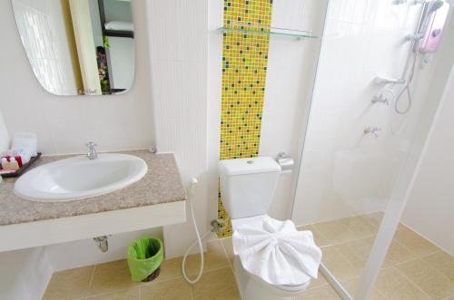 a bathroom with a sink and a toilet and a shower at NP Hotel in Buriram