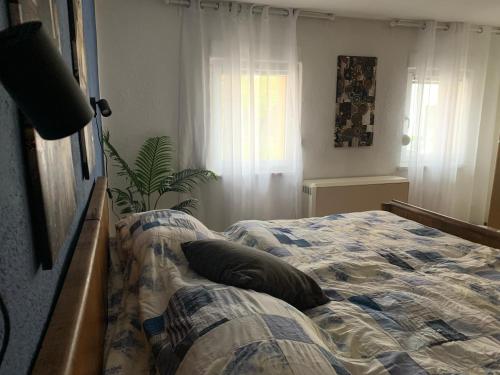 a bedroom with a bed with a pillow on it at Willma Ferienhaus in Altdöbern