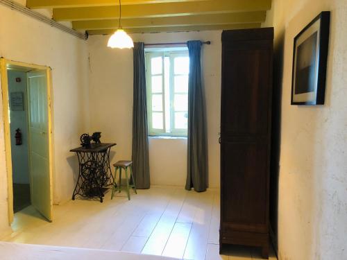 a room with a window and a table with a chair at Gîte au Bray in Bellenaves