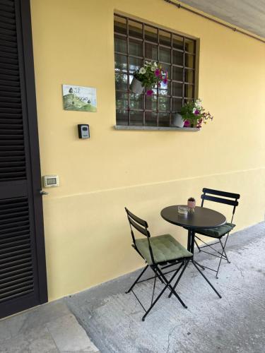 a table and two chairs sitting next to a building at Casa vacanze Il Poggio in Fabro