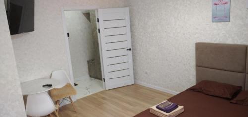 Habitación pequeña con dormitorio con puerta blanca en Новая 1 комнатная квартира в мкр Аэропорт en Kostanái