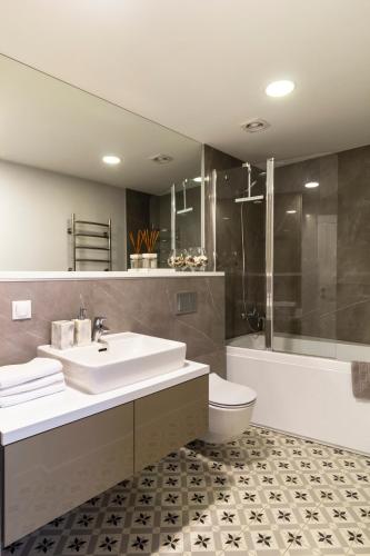 a bathroom with a sink and a toilet and a shower at Elija Penthouse with Sea View & Terrace - Near Beach - Free Parking in Palanga