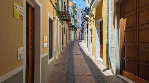 an empty alley way in a city with buildings at POSIDONIO old town apartment in Villajoyosa