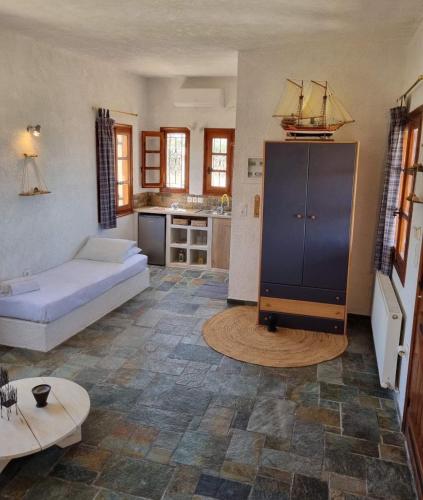 a living room with a couch and a kitchen at Fay's View Aegina in Egina