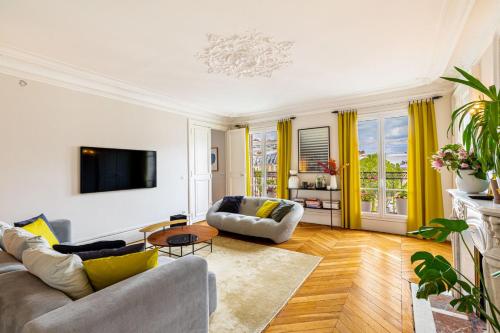 un salon avec un canapé et une télévision dans l'établissement GuestReady - Stately Haven near Pantheon, à Paris