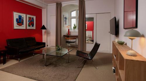 a living room with a couch and a table at Hotel Alexandra in Copenhagen