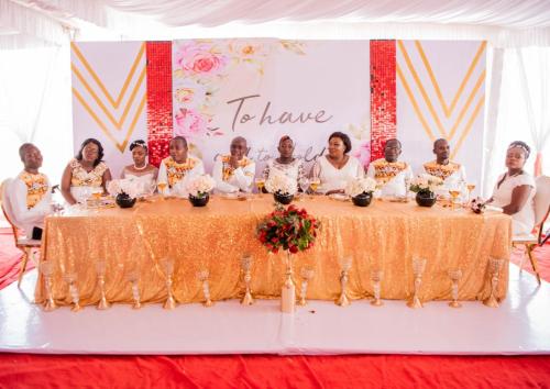 a group of people standing around a table at The Loch Hotel Bondo in Bondo