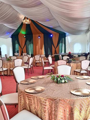 a tent set up for a wedding with tables and chairs at The Loch Hotel Bondo in Bondo