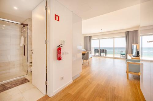 a living room with a view of the ocean at GuestReady - Beachfront Naufrago's Retreat 2 in Sesimbra