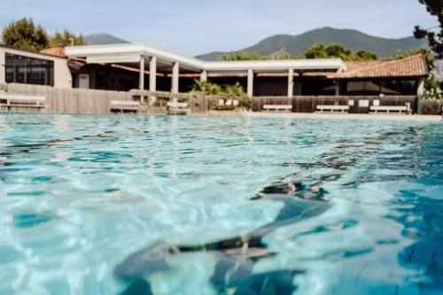 a pool of water in front of a building at Camping Del Sole Village in Iseo