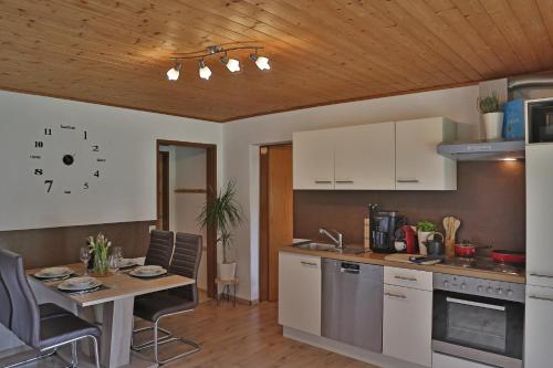 a kitchen with a table and a dining room at Apartment Alpenwelt in Neustift im Stubaital