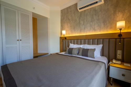 a bedroom with a large bed in a hotel room at DeMANOR HOTEL ADULT ONLY in Alanya