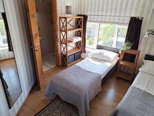 a small room with two beds and a window at Kraavi Guest Hostel in Kuressaare