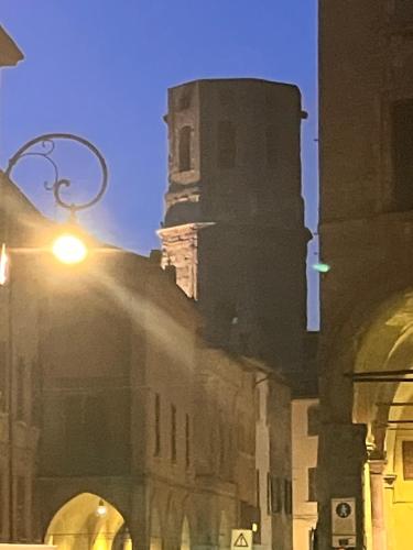 a building with a clock tower and a street light at ROSSENA HOME tranquillo appartamento, con giardino, vicino al centro ed all'Ospedale Santa Maria Nuova SMN in Reggio Emilia