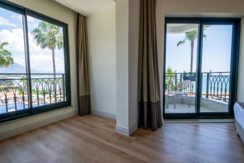 a room with large windows with a view of the ocean at DeMANOR HOTEL ADULT ONLY in Alanya