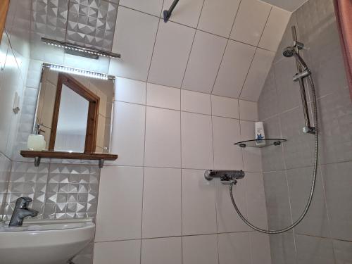 a bathroom with a shower and a sink at Kraavi Guest Hostel in Kuressaare