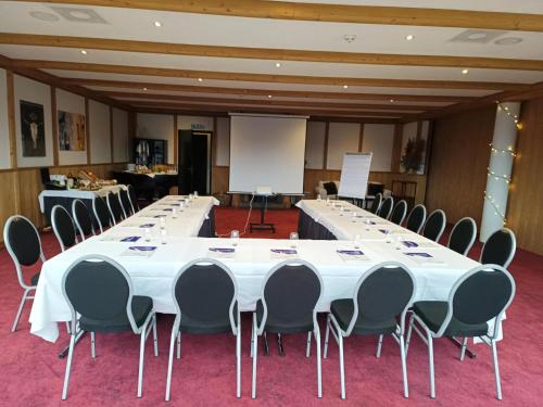 a large conference room with a long table and chairs at Hôtel Chalet Royal in Veysonnaz