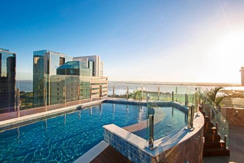 a swimming pool on top of a building at Intercity Porto Alegre Praia de Belas in Porto Alegre