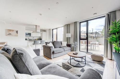 a living room with a couch and a table at GuestReady - Olympic Park City Living in London
