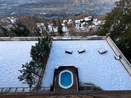 a building with a blue door in the snow at Hôtel Chalet Royal in Veysonnaz