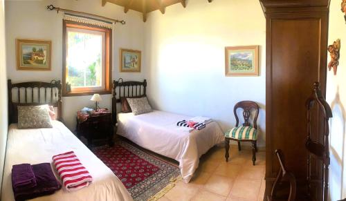 a bedroom with two beds and a window at Apartamento MAR Y TEIDE in Sauzal