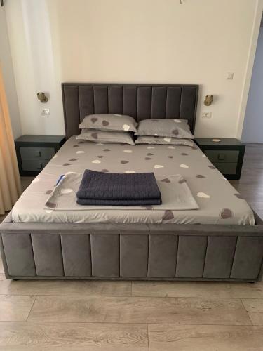 a bed in a bedroom with a gray bed frame at Casa Ștefan in Eforie Sud