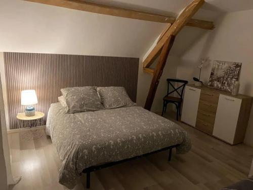a bedroom with a bed and a table with a lamp at Charmante maison à Troyes avec terrasse et jardin clôturé in Troyes