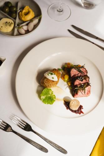 a white plate with food on a table at Zoomers aan het Bos in Castricum