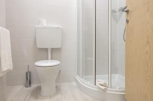 a bathroom with a toilet and a glass shower at Hotel Continental in Caorle