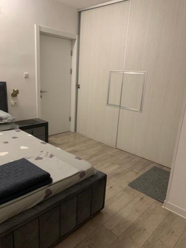a bedroom with a bed and a sliding door at Casa Ștefan in Eforie Sud