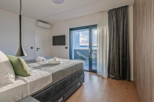 a bedroom with a bed with a view of the ocean at Villa Petrea in Novigrad Dalmatia