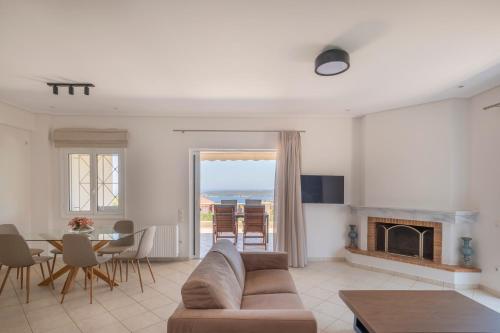 a living room with a couch and a table at Villa Katrin 2 in Pylos