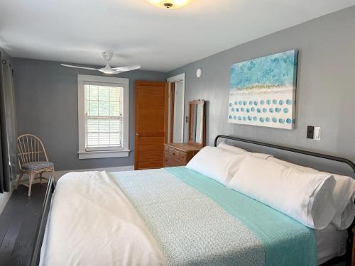 a bedroom with a bed and a painting on the wall at NH311B Nags Head 311B in Nags Head
