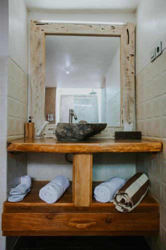 a bathroom with a sink and a mirror at Wage cottage in Nusa Penida