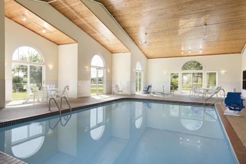 an indoor swimming pool with a wooden ceiling at Country Inn & Suites by Radisson, Mason City, IA in Mason City