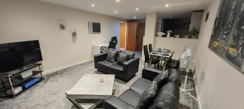 a living room with a couch and a table at Paramount city view in Swindon