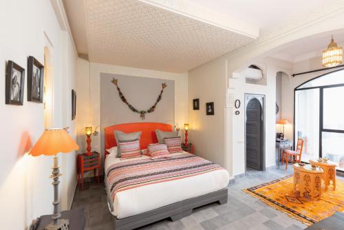 a bedroom with a bed with pillows on it at Riad Sybil Boutique Hotel in Marrakech