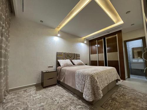 a bedroom with a large bed and a large window at Appartement à plage Dalia in Dalia