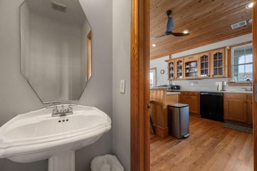a bathroom with a sink and a mirror at MS22 Sandpiper's Retreat in Nags Head