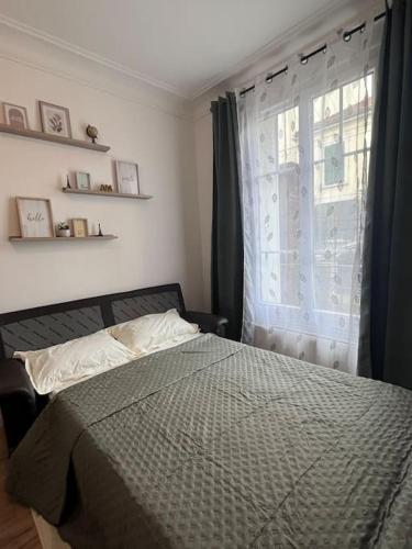 Ένα ή περισσότερα κρεβάτια σε δωμάτιο στο Appartement T2 aux portes de Paris