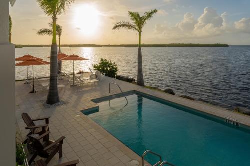 a swimming pool with a view of the water at Tranquility #19 in Key Largo