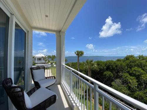 a porch with a chair and a view of the ocean at Endless Summer 42 in Key Largo