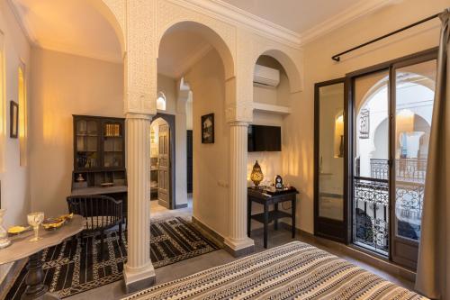 a living room with a bed and a table at Riad Sybil Boutique Hotel in Marrakech