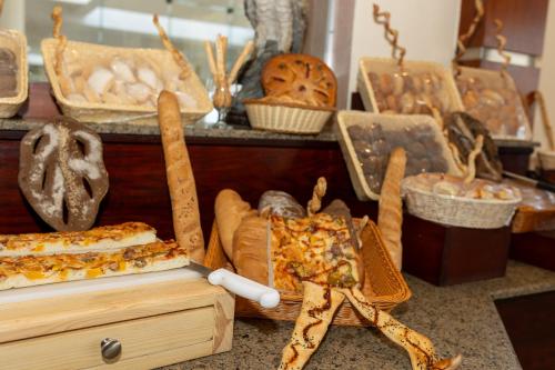 a table with many different types of bread and pastries at The Makadi Spa Hotel - Couples Only 18 Years Plus in Hurghada